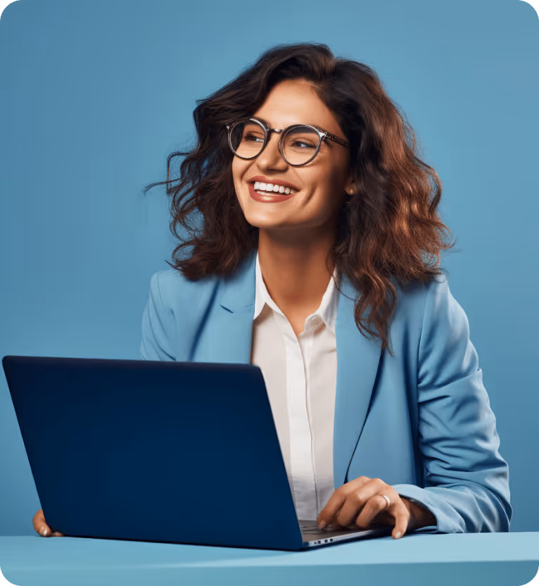 Smiling middle-aged man wearing a light blue shirt sitting in a white chair using a laptop against a blue background.
