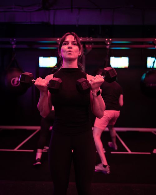 A woman looks through a training machine.