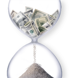 An hourglass filled with US dollar bills in the top chamber trickling down into sand in the bottom bulb on a white background.