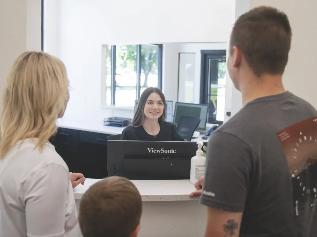 Front desk team member welcoming a family