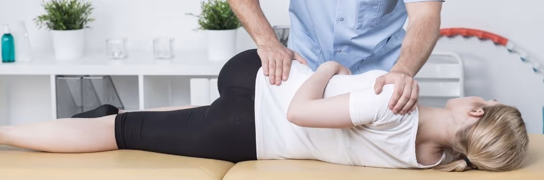 chiropractor adjusting patient