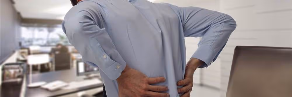 patient showing where pain is on lower back