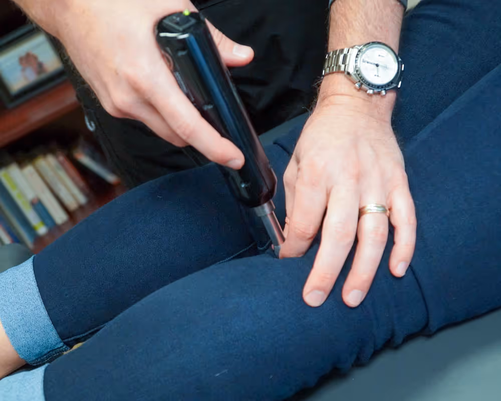 chiropractor adjusting leg
