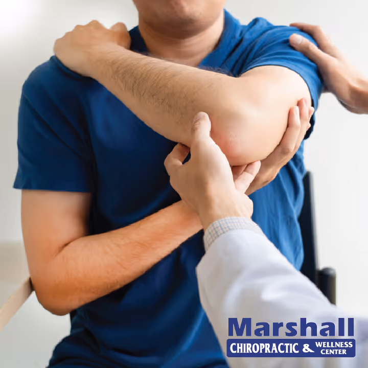 patient showing shoulder pain to chiropractor