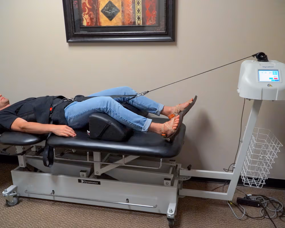 client on machine at chiropractor