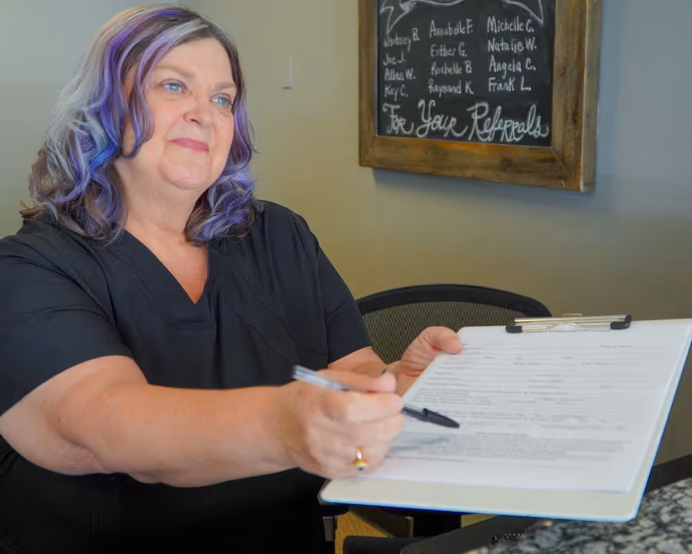 team member giving paperwork to client