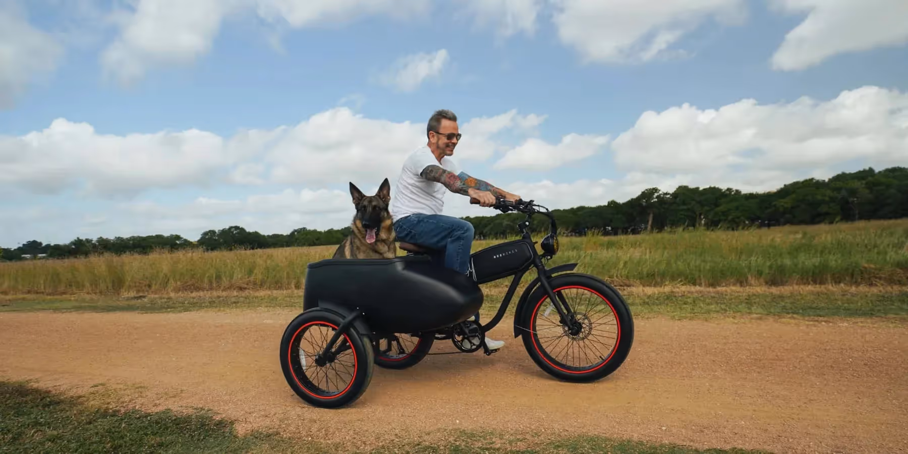 Man rides a Mod Easy Sidecar electric bike with a german shepard dog riding in the sidecar