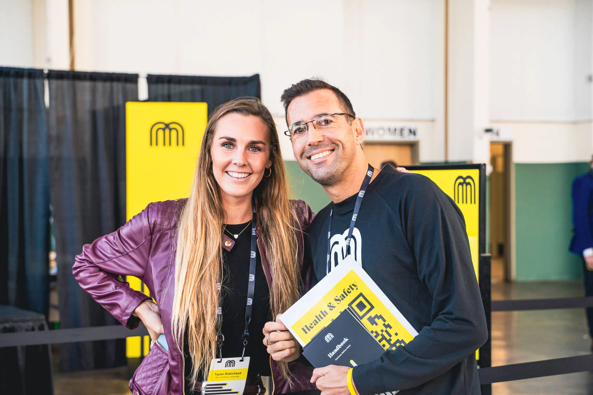 Taylor Robichaud and Alex Gaber greet attendees at Micromobility America 2022