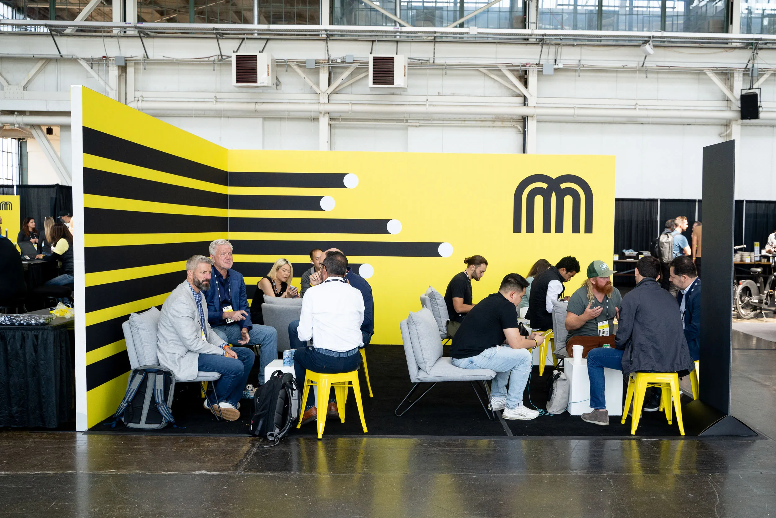 Attendees and exhibitors relax and meet in Ride Review lounge at Micromobility America 2022