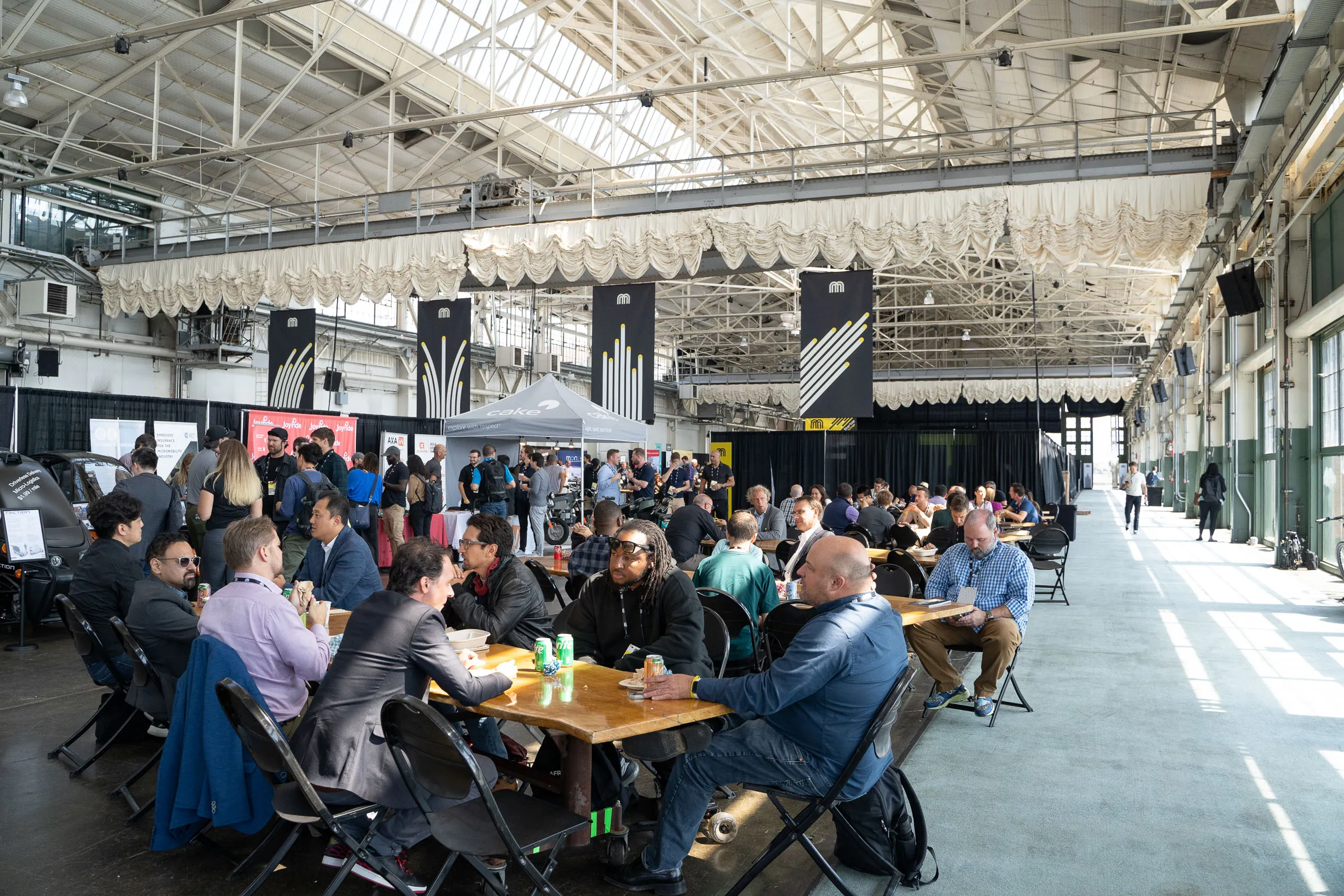 Attendees and exhibitors relax and meet in common areas at Micromobility America 2022