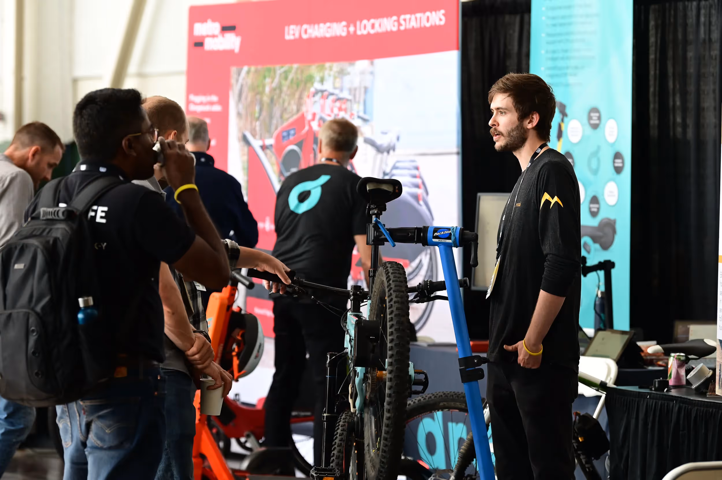 Bimotal employee talks to attendee at Micromobility America 2022