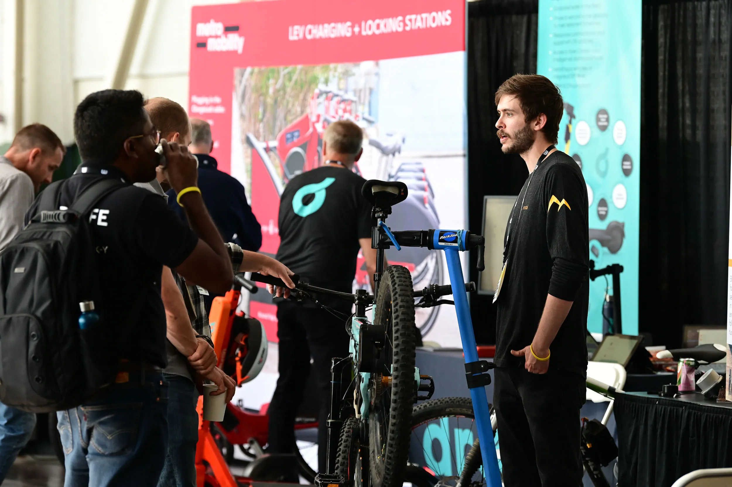 Bimotal employee talks to attendee at Micromobility America 2022