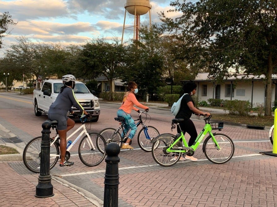 People use bicycles, including an e-bike (in lime green above) to participate in Eatonville’s Bike Ride Through Black History in February 2021.