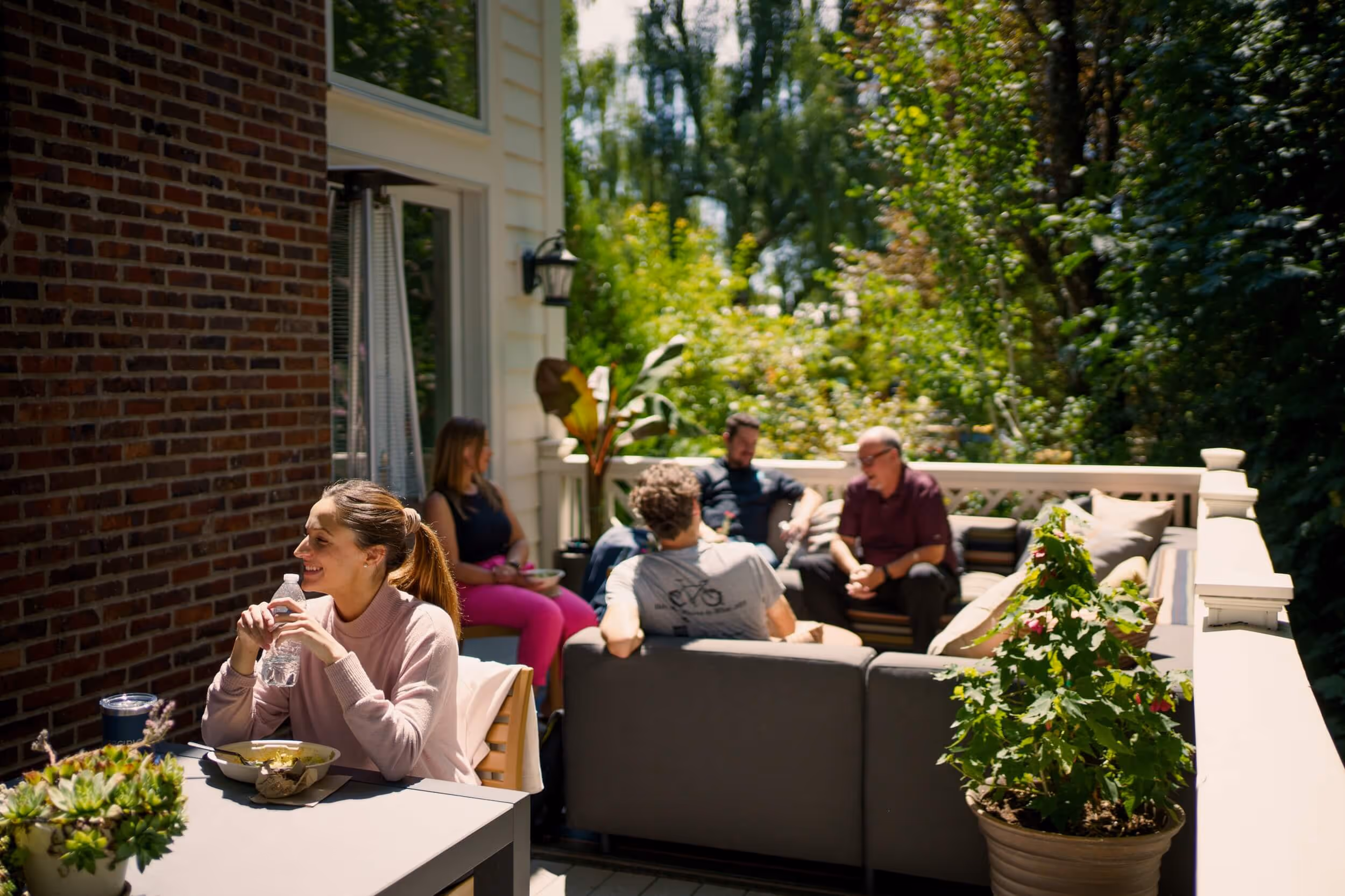 a group of people sitting on top of a patio