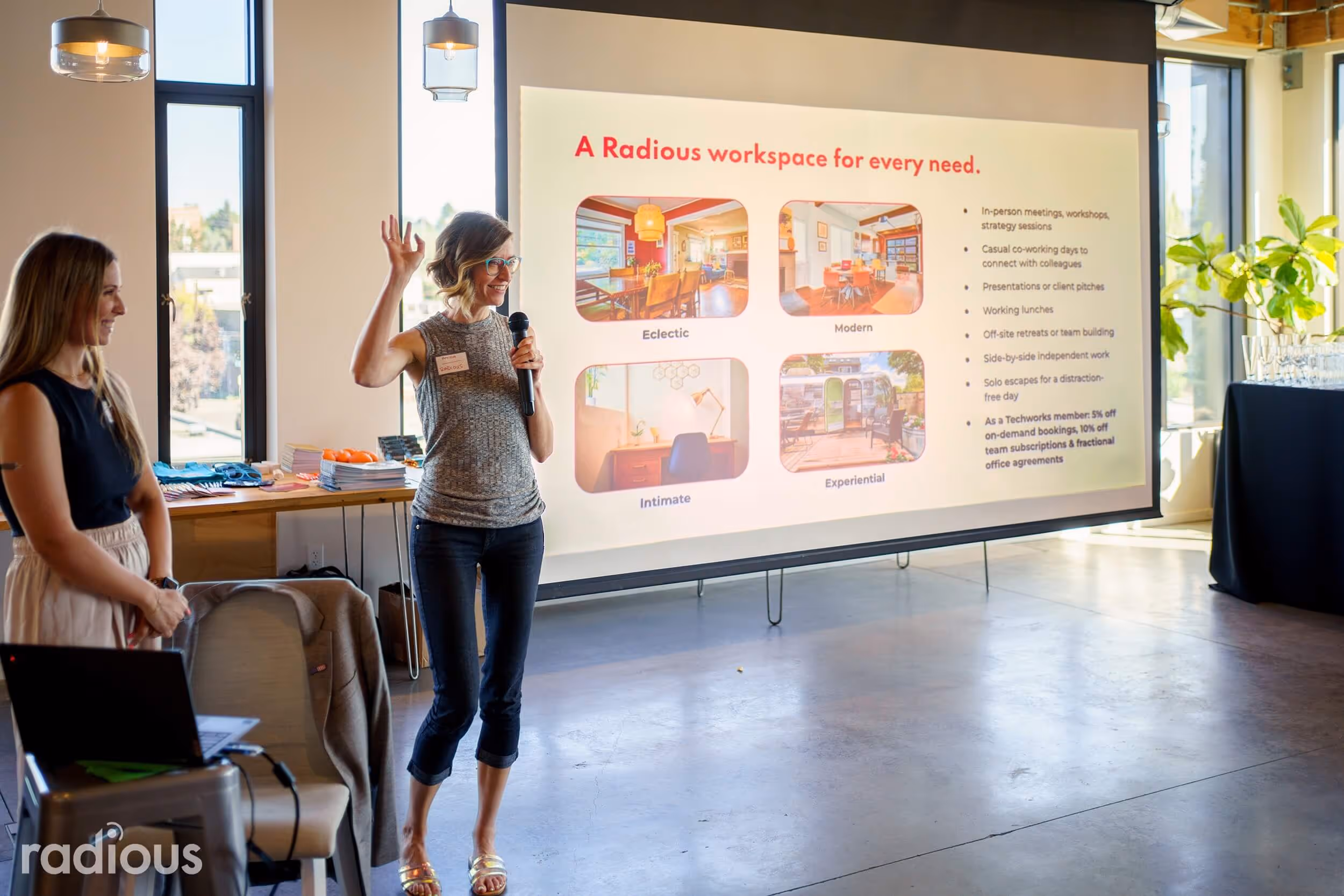 a woman standing in front of a projector screen giving a presentation