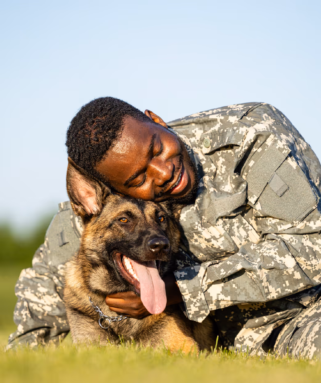 Solider hugging panting dog