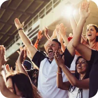 An excited cheering crowd in a stadium. 