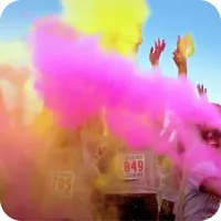 People throwing colorful Holi powder in the air. 