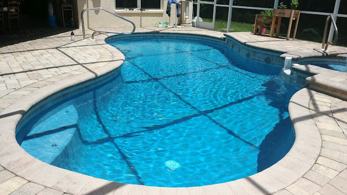 Freeform swimming pool and paver deck