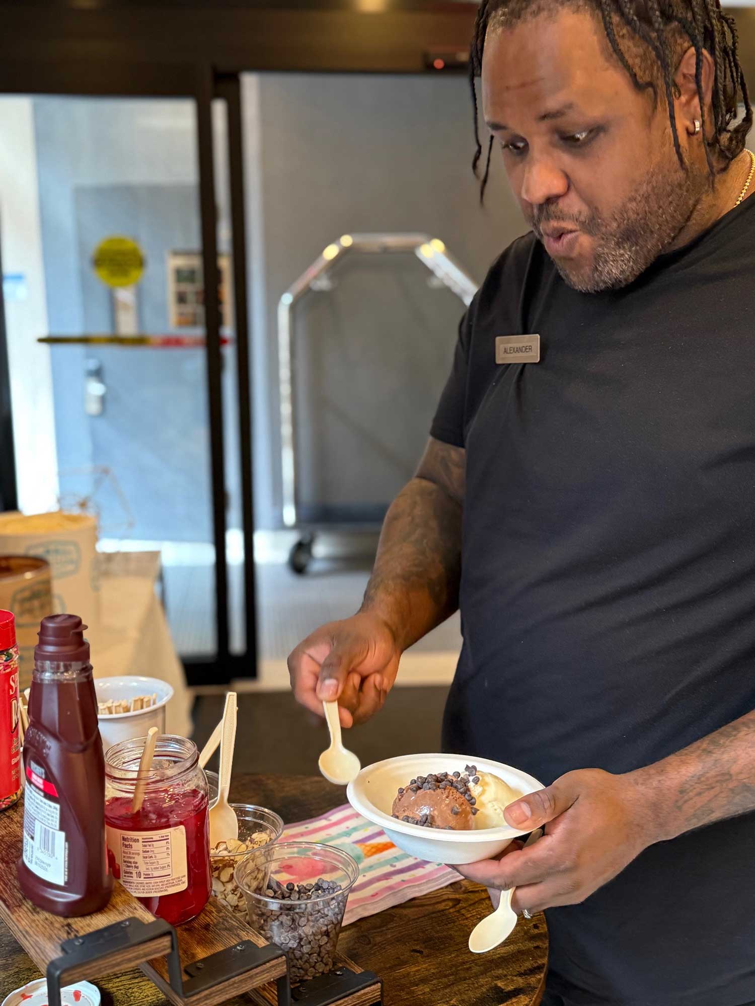 Alexander Vargas, house attendant, takes a sweet break to build his own sundae at the Fairfield New York Manhattan/Central Park’s ice cream social.