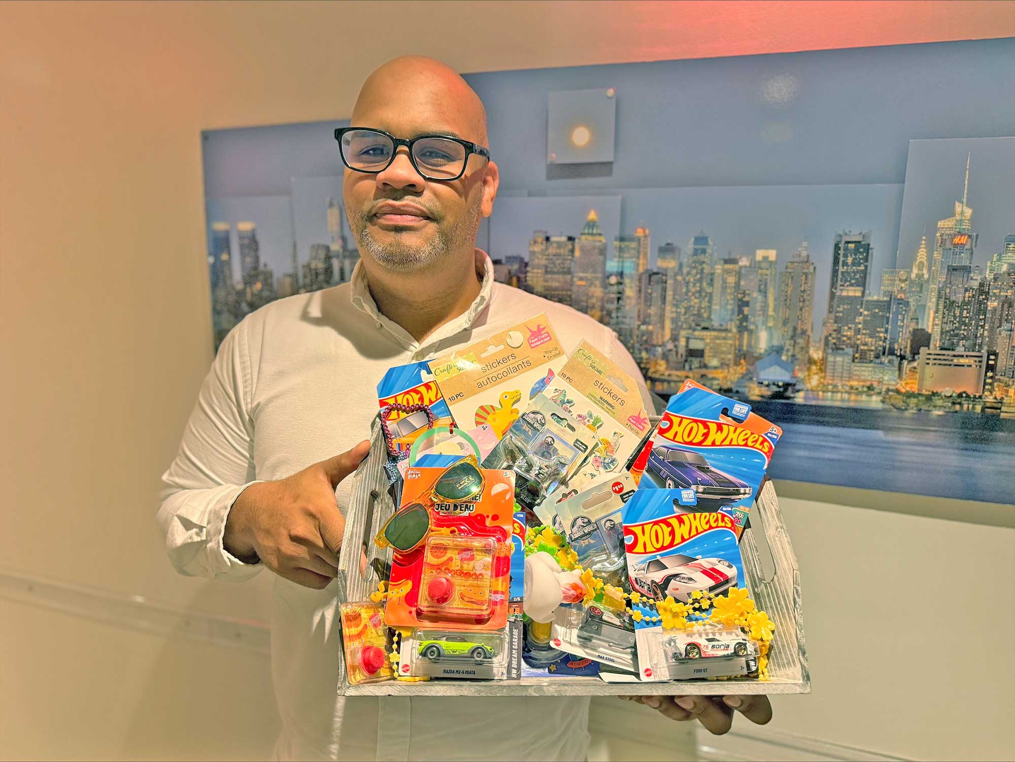 Assistant General Manager Francisco Matias displays toys for young guests who stay at the Fairfield New York Manhattan/Central Park with their families during the summer travel season.