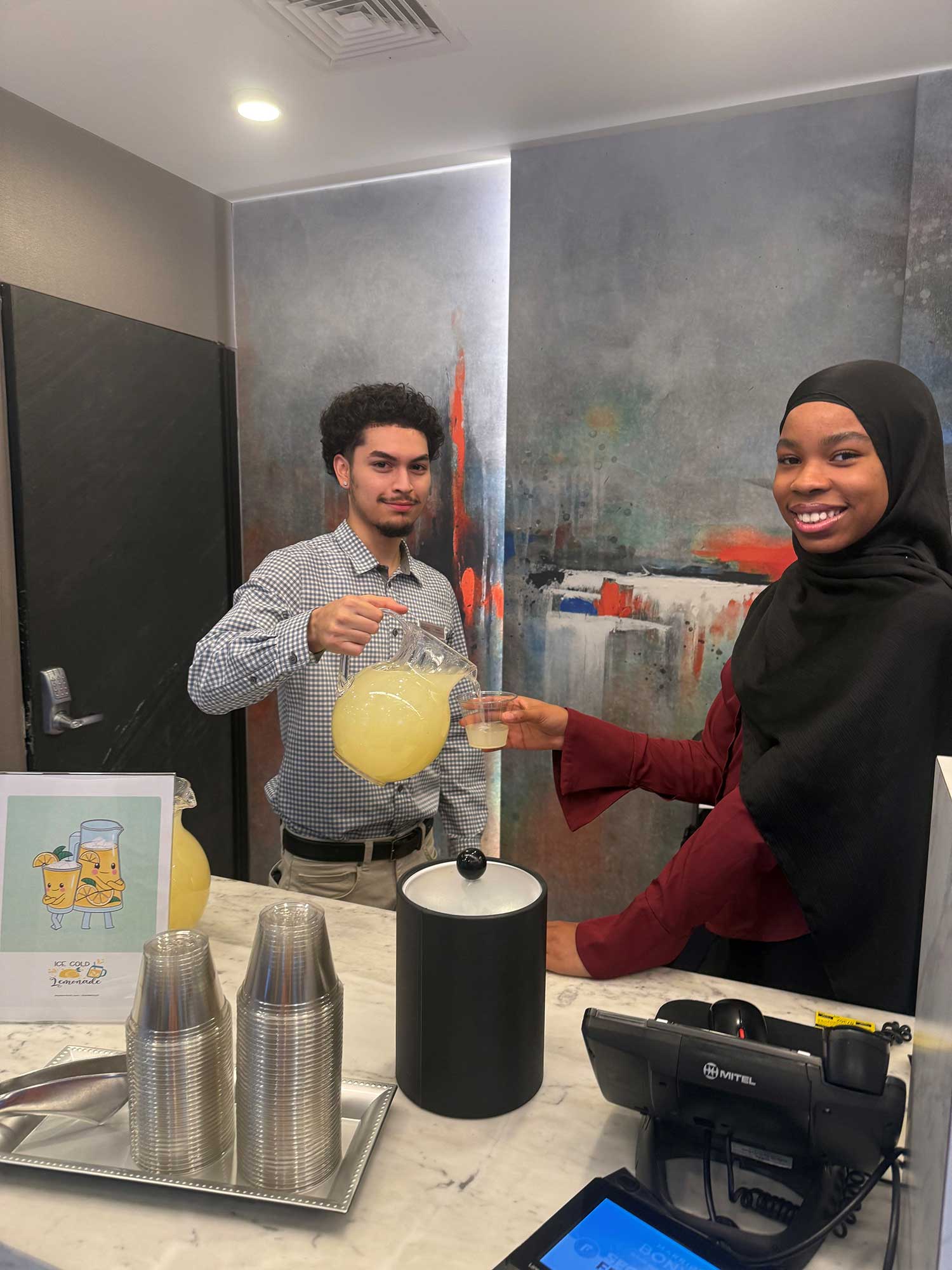 The Fairfield New York Manhattan/Central Park front desk team serves iced lemonade at check-in for a personal and refreshing touch.