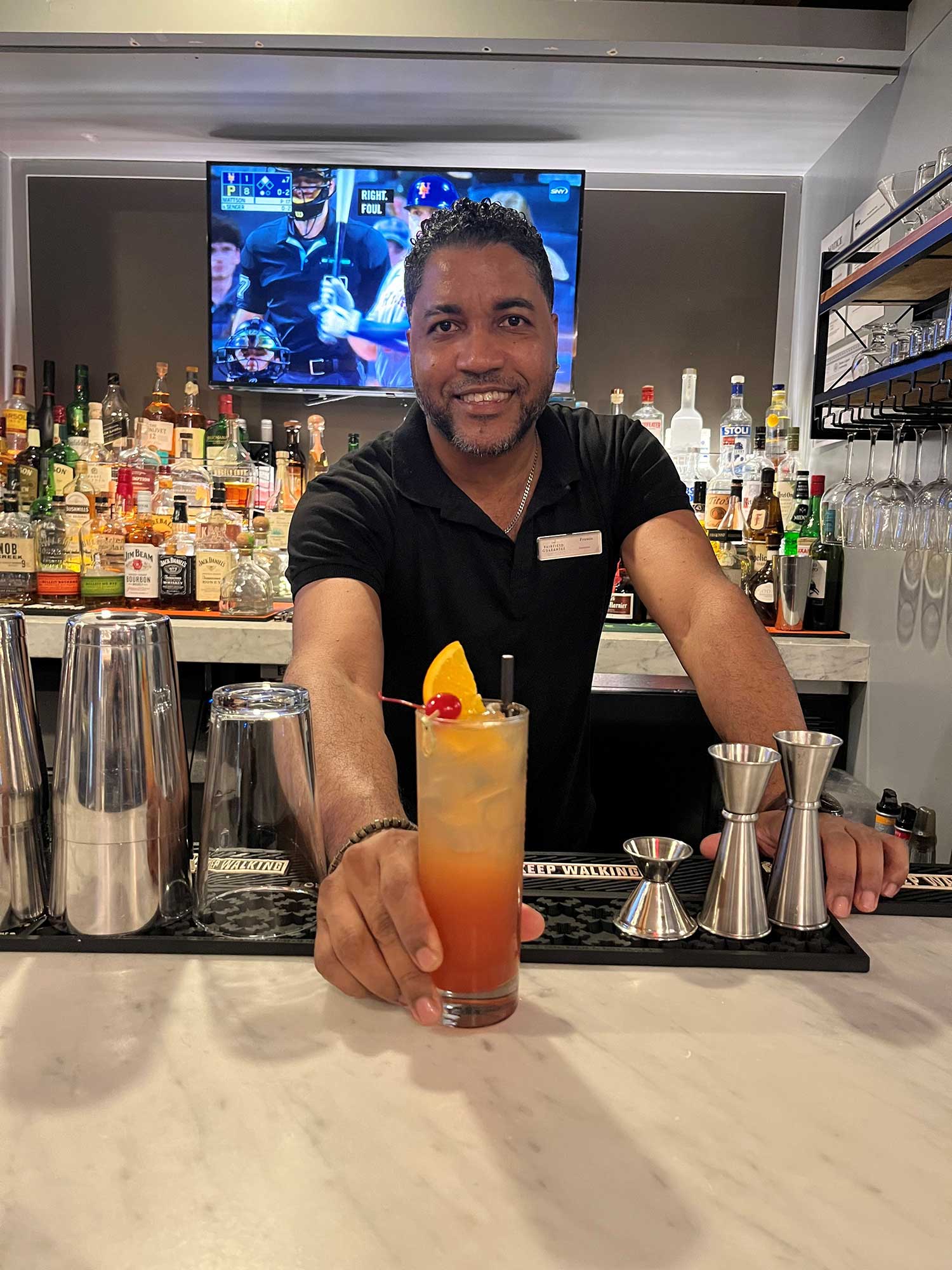 Bartender Francis Espinosa presents a summer cocktail at the Fairfield New York Manhattan/Central Park’s Bar 58.