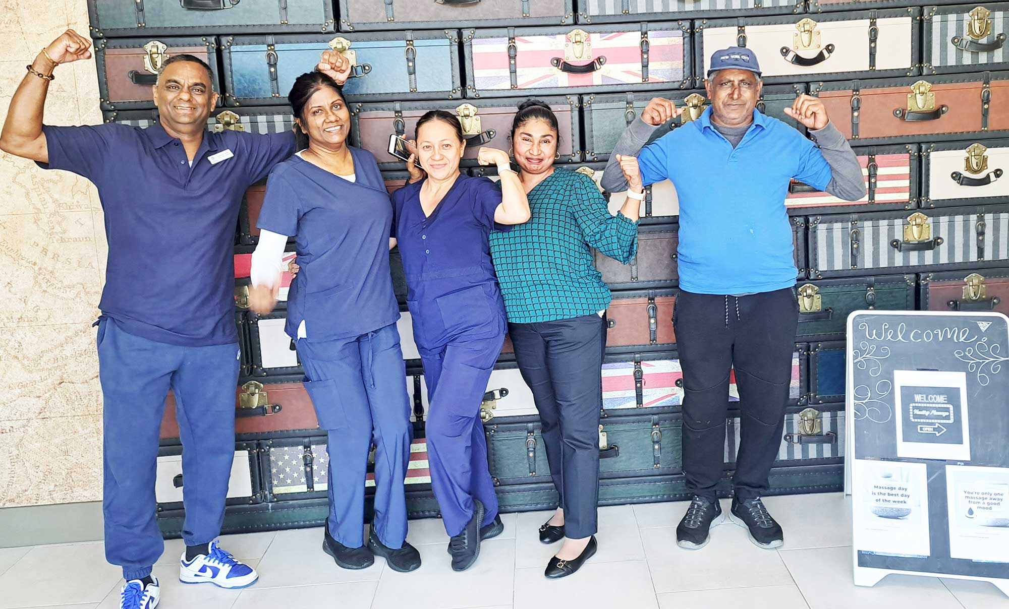 Staff members at the Best Western JFK Airport Hotel show off their strength during M&R’s ‘Wellness Week.’