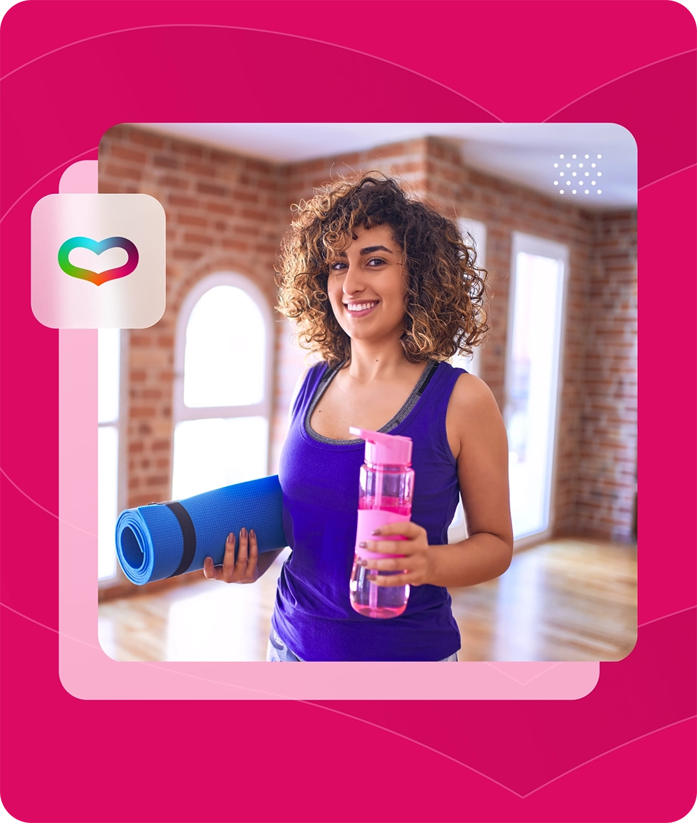 Woman with yoga mat and water bottle smiling.