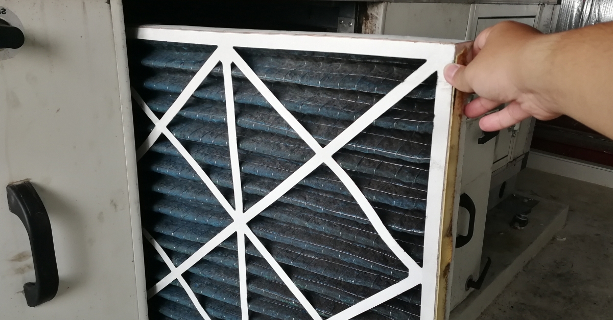 Hand holding clean HVAC air filter for home furnace system maintenance