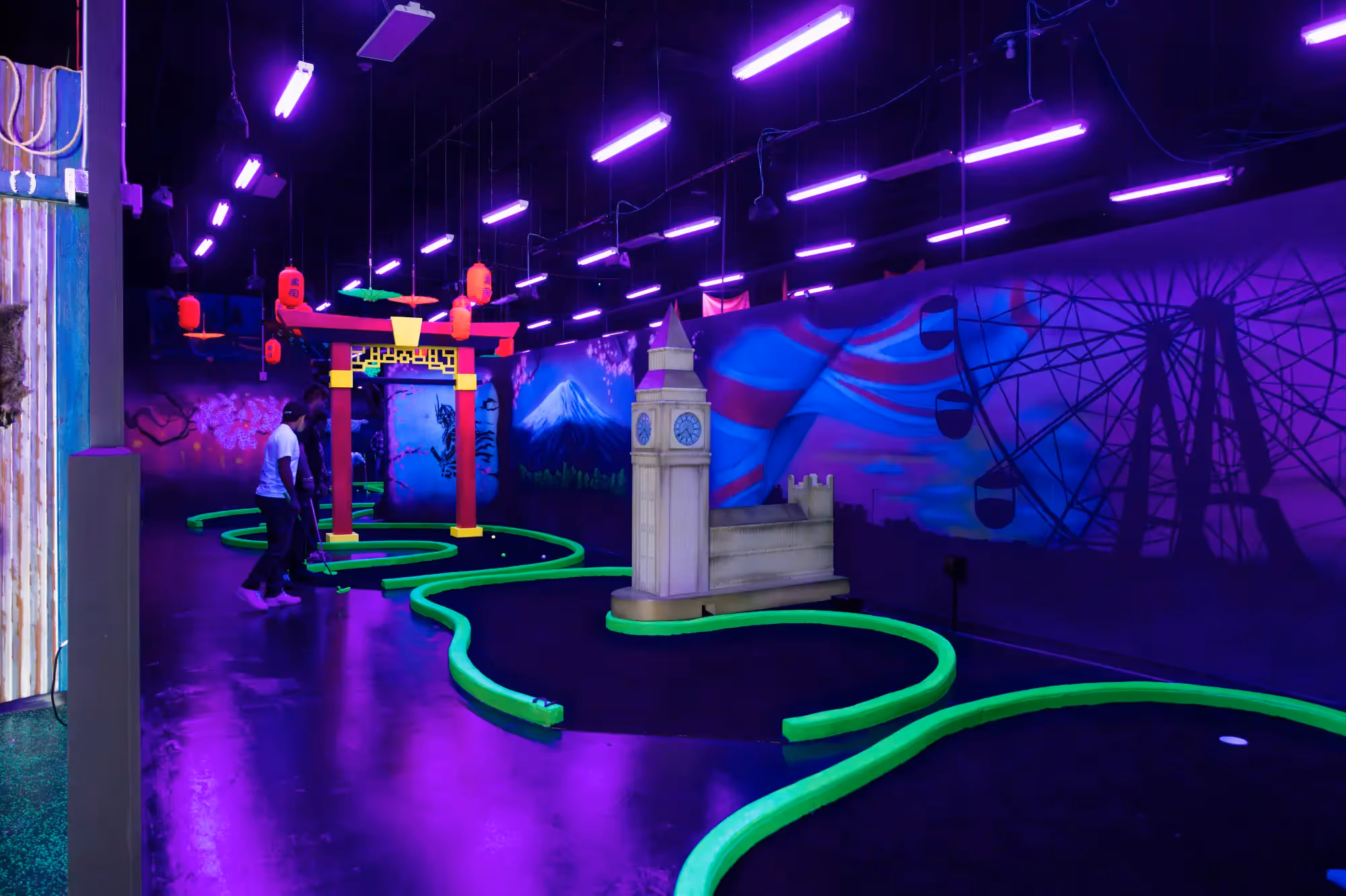 A purple room with a roller coaster and a clock.