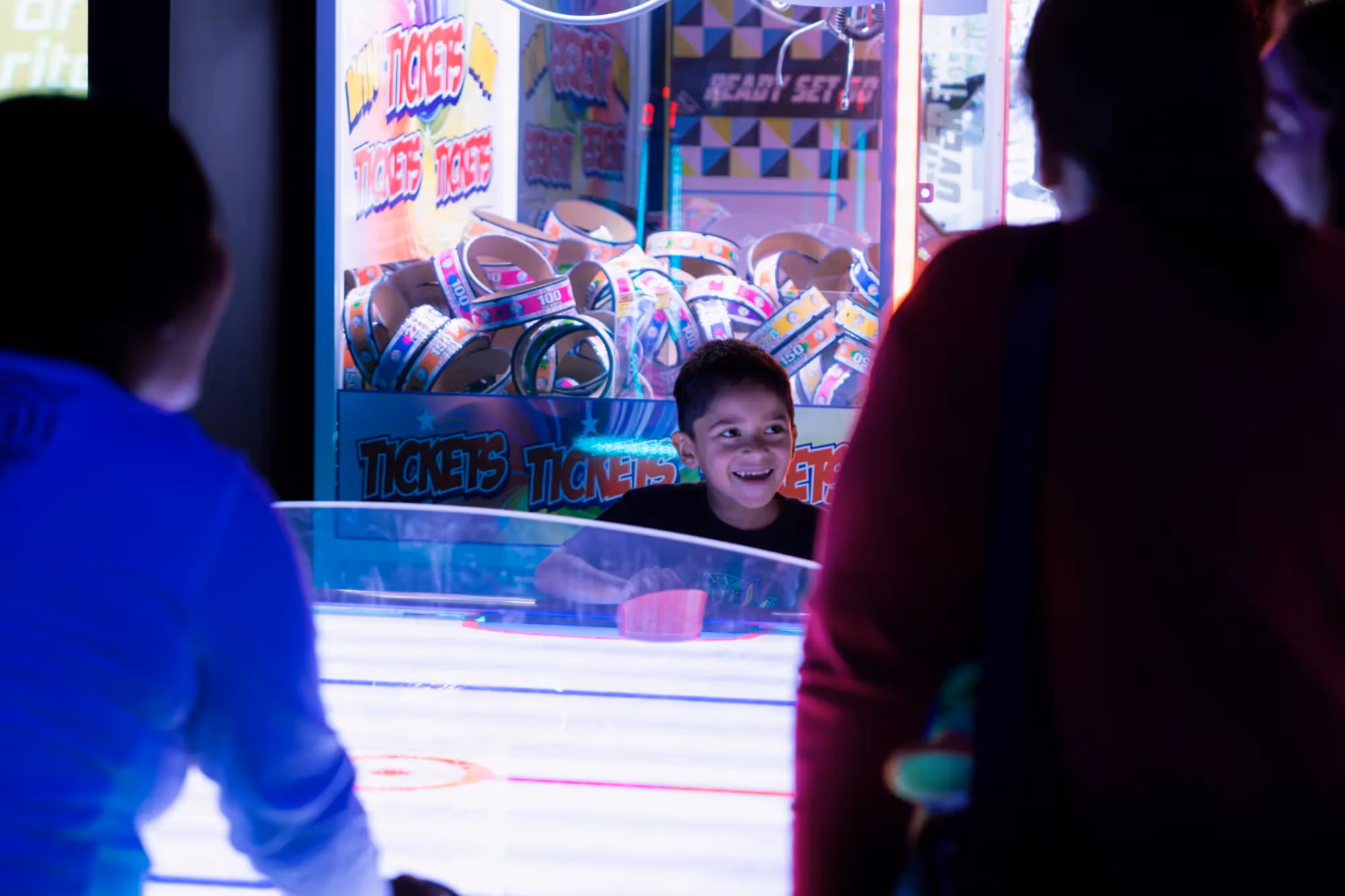 A young boy is playing a video game in a dark room.