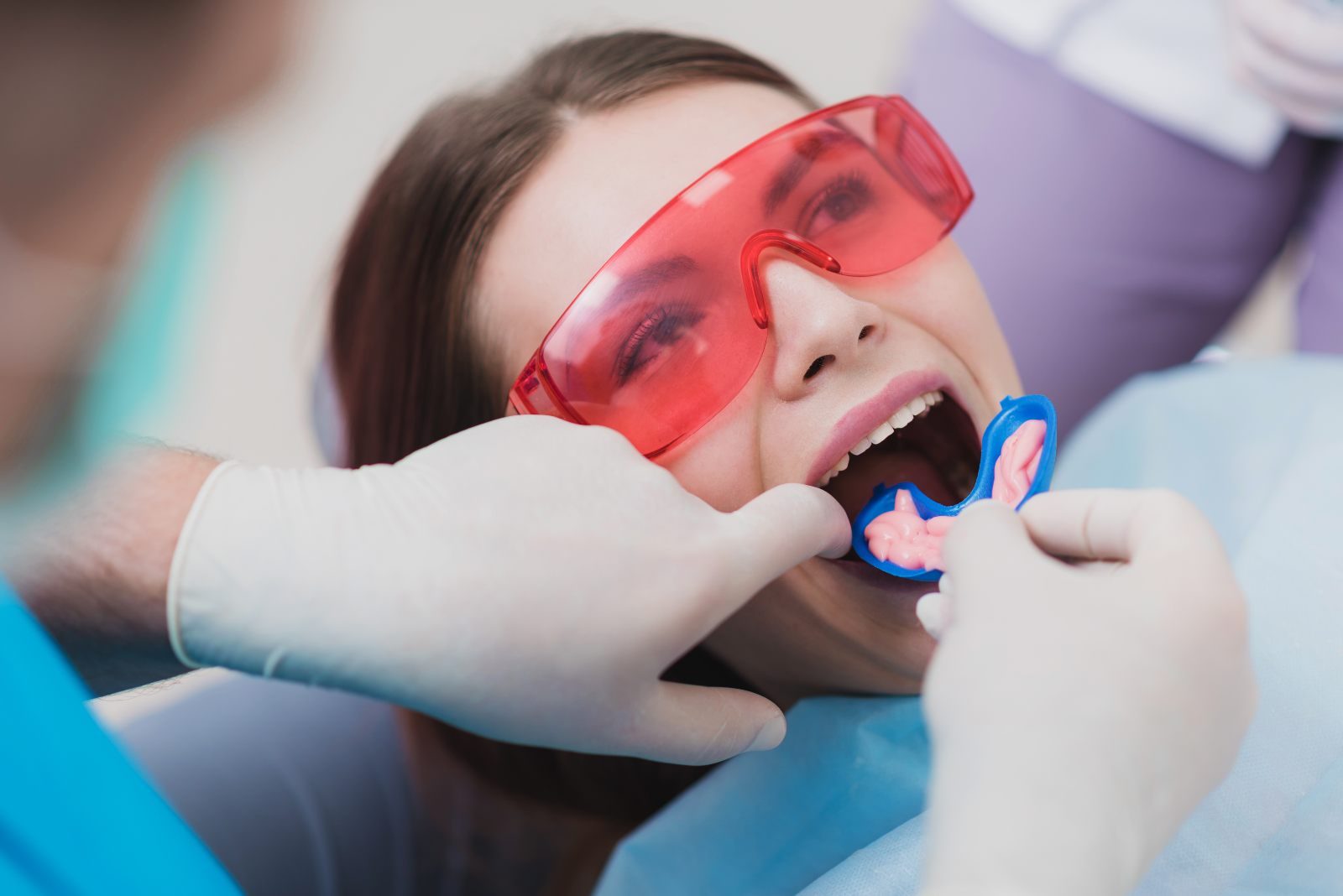 Patient wearing protective eyewear during an in-office dental treatment