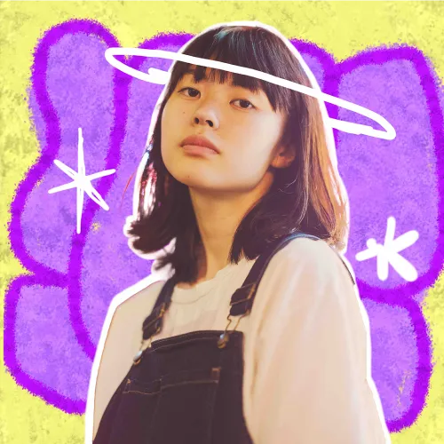 an Asian girl in front of a yellow and purple graffiti wall
