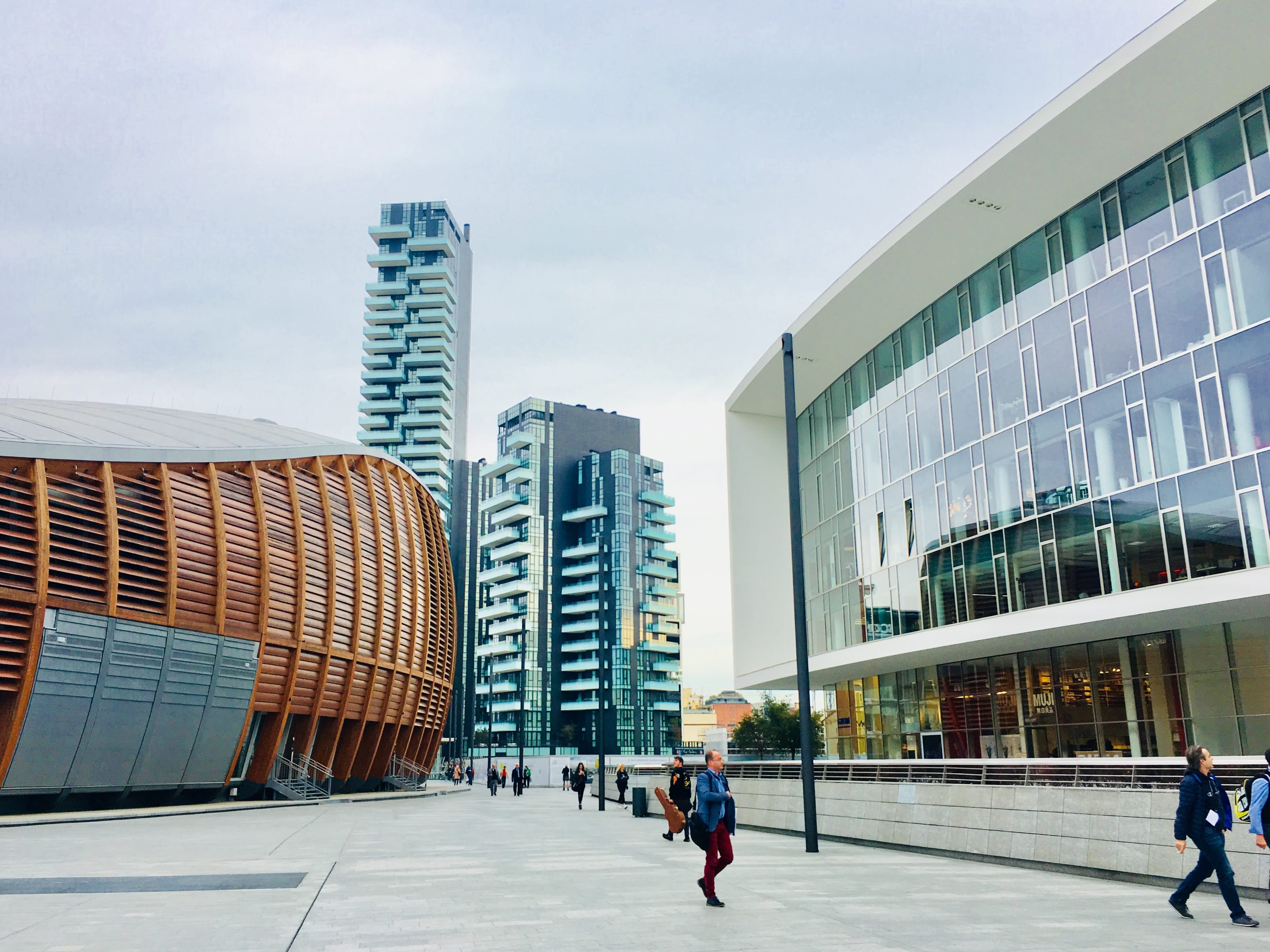 Beautiful photography of a downtown office area with people walking. Photo by Erin Doering.