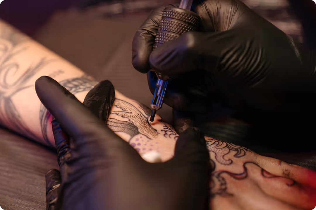 Tattoo artist giving a tattoo up close shot