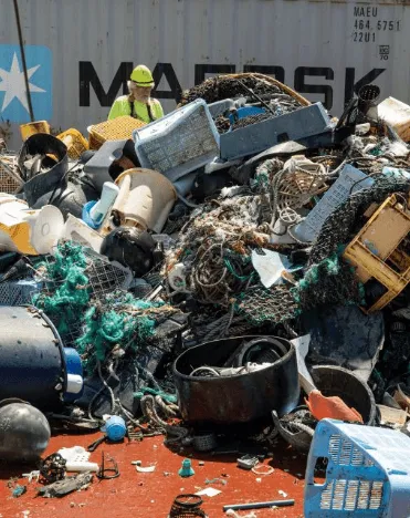 Trash gathered from the sea sits on a boat