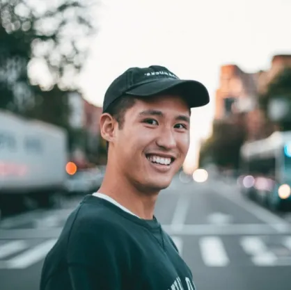 A man smiling in a city street