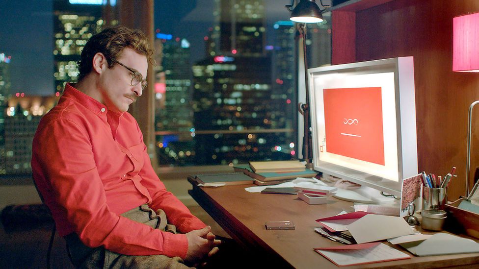 Joaquin Phoenix in the movie Her, staring at a computer loading screen.