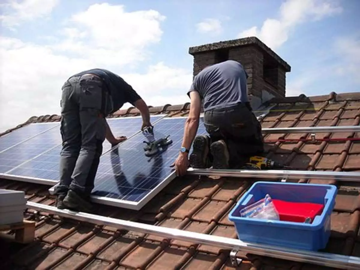 Solar installers mounting solar panels 