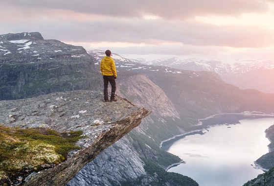 A person standing on the edge of a cliff
