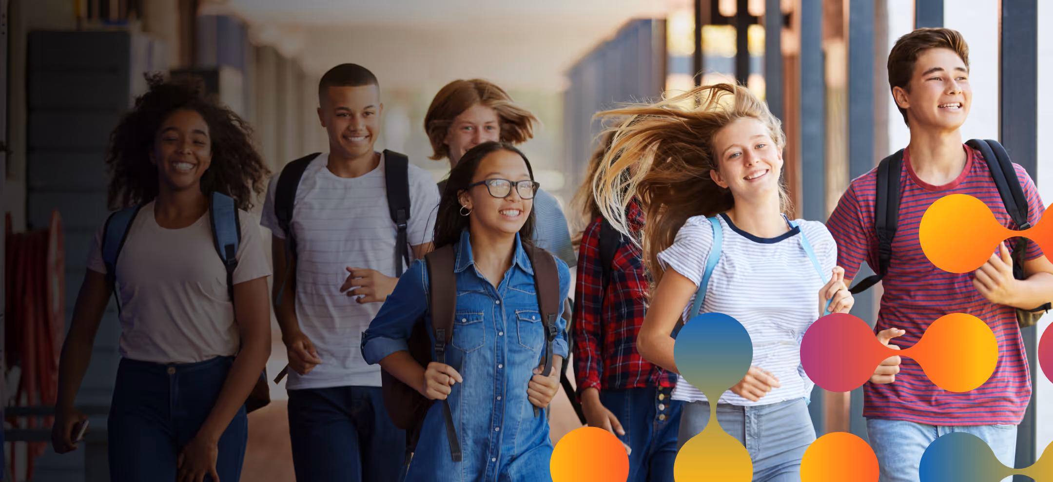 A group of students walking down a school hallway.