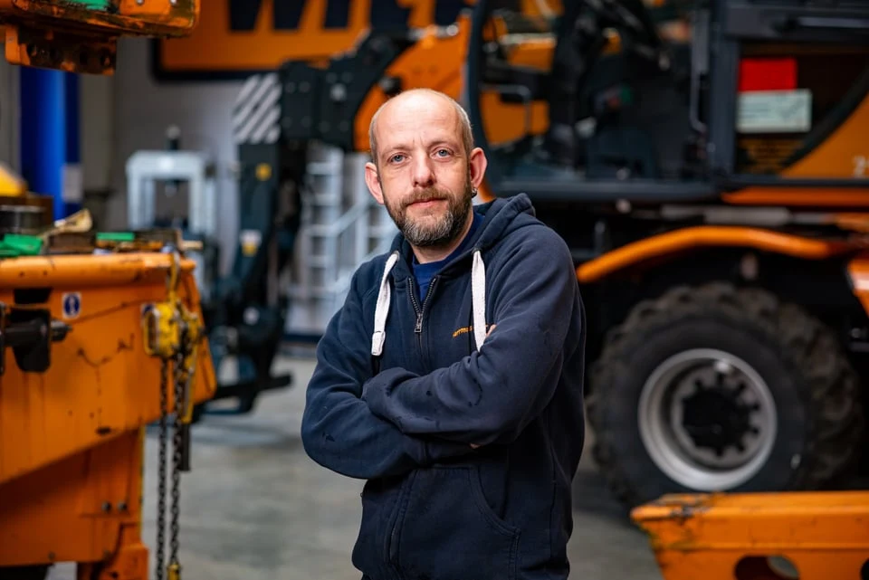 Mitarbeiter von Herrmann & Wittrock mit verschr&auml;nkten Armen vor Fahrzeug