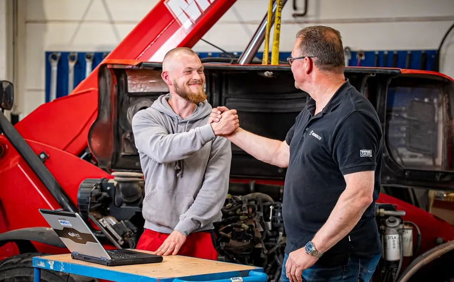 Servicetechniker beim Handschlag mit einem Kollegen