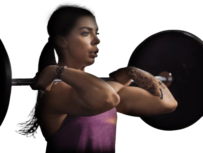 Woman with tattoos lifting a barbell in front rack position, wearing a purple tank top.