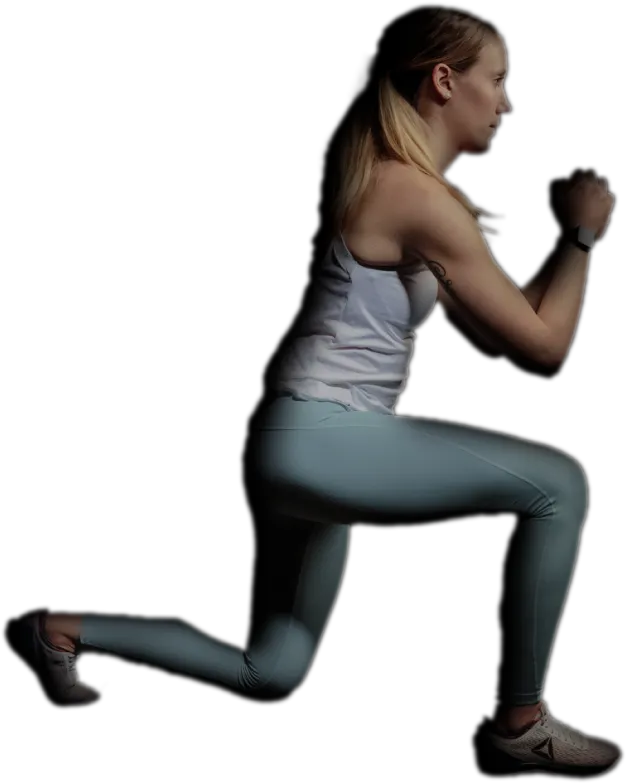 Young woman in athletic wear performing a lunge exercise against a black background.