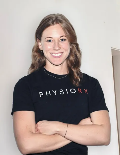 Melissa Foster, CPT, PN1, coach at PhysioRX in New York City, arms crossed in a PhysioRX T-shirt