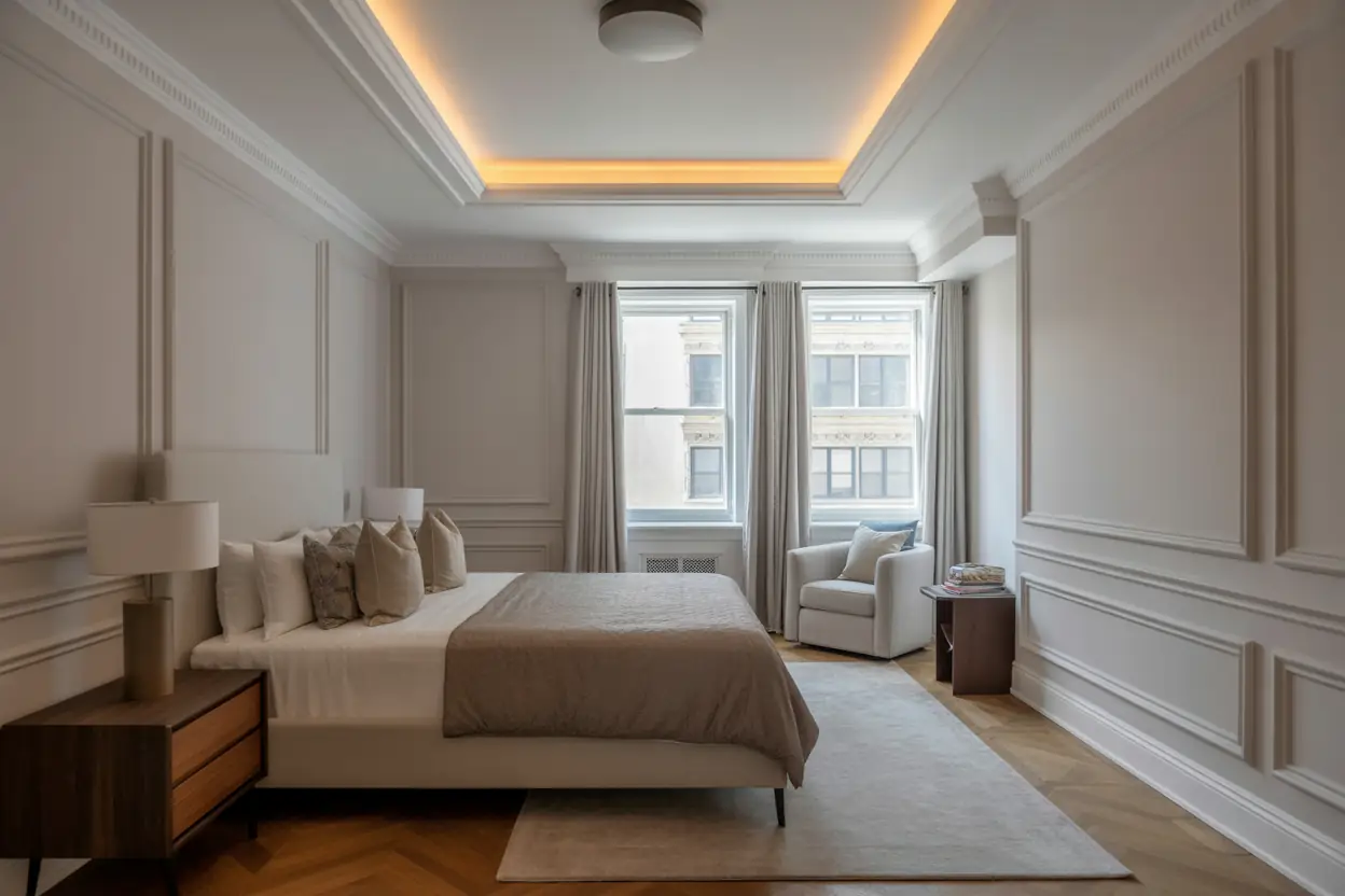 Coffered tray ceiling with integrated LED lighting in a luxury bedroom.