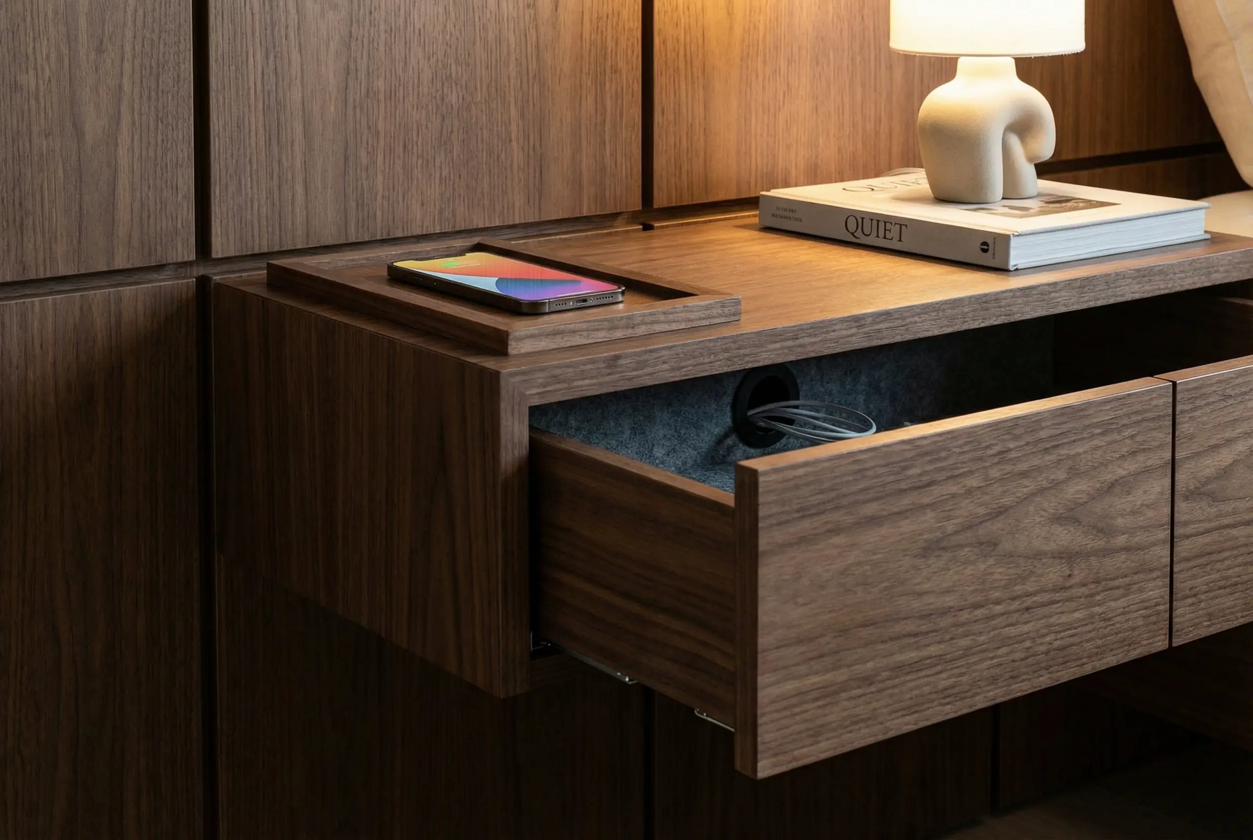 an ultra-realistic photo of a custom built-in nightstand with hidden compartment and clean cable management for a clutter-free luxury bedroom.