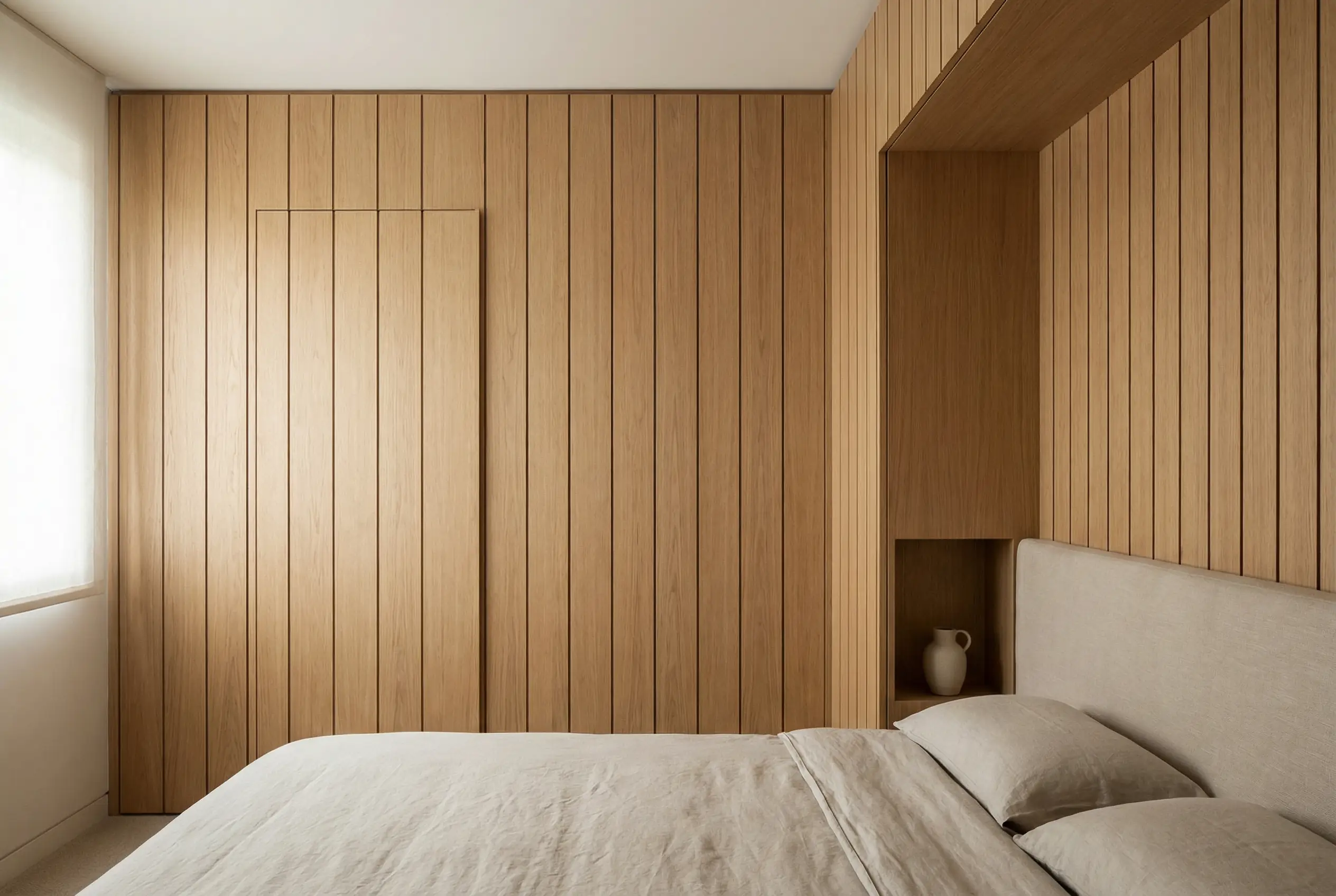 an ultra-realistic photo of seamless custom wall paneling that connects a built-in headboard to closet doors for a smooth, calming bedroom look.